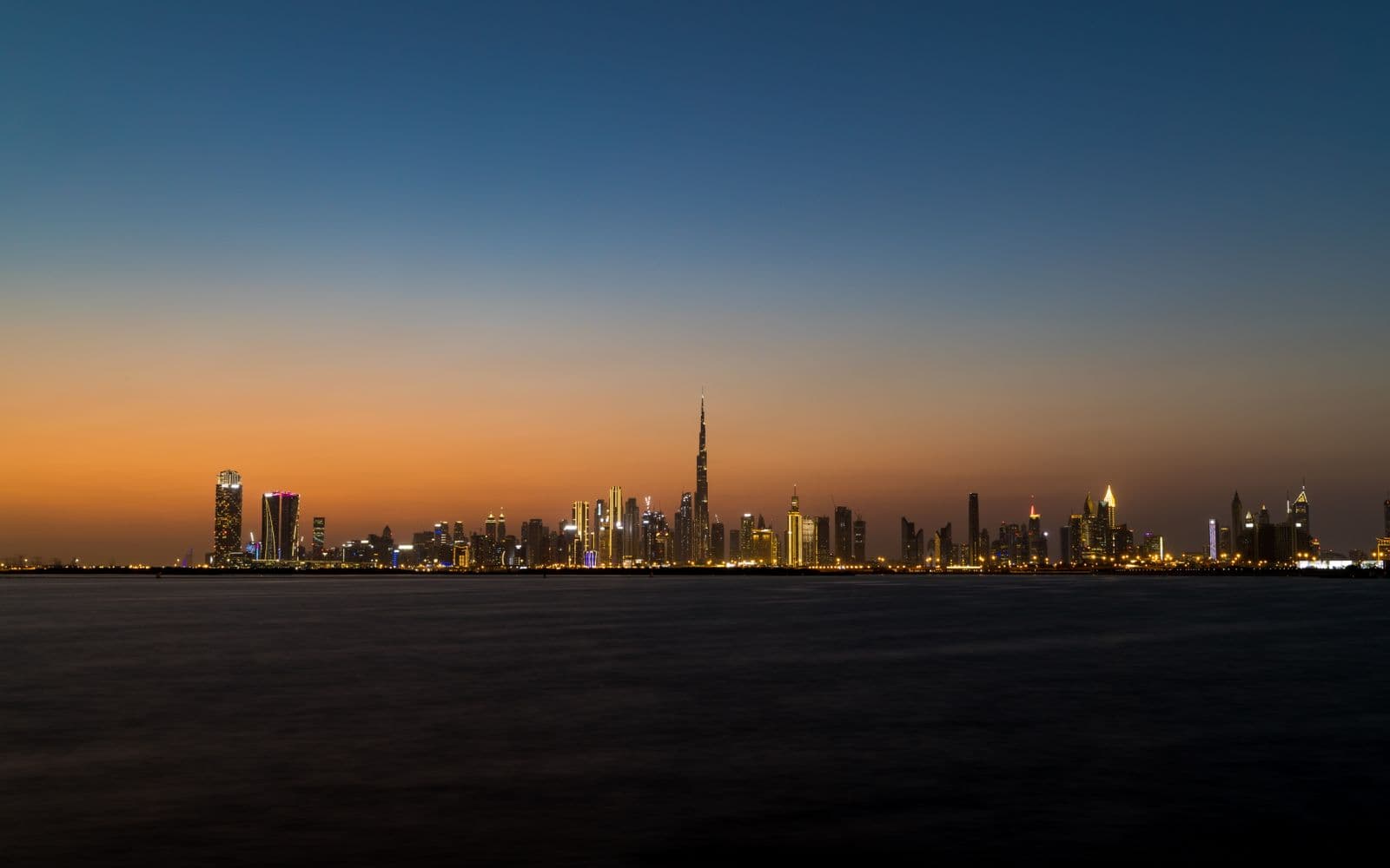 Dubai skyline at twilight with the Burj Khalifa rising above the sea